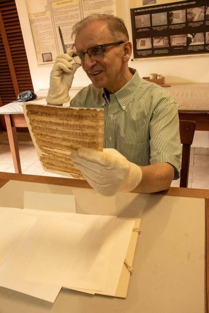 Rev. Piotr Nawrot, S.V.D. studying the archival music at the Concepción Cathedral collection (photo courtesy of APAC)