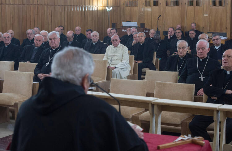 Pope Francis, along with senior members of the Roman Curia, listen as Servite Father Ermes Ronchi, an Italian theologian, delivers his meditation during a weeklong Lenten retreat in Ariccia, Italy, March 7. (CNS photo/L'Osservatore Romano, handout)