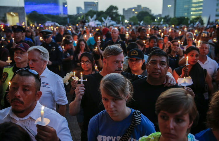 People participate in a candlelight vigil July 11 at the Dallas City Hall Plaza. (CNS photo/Erik S. Lesser, EPA) 